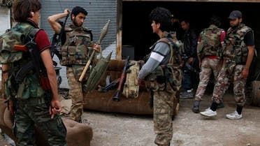 Rebel fighters hold their weapons during preparations ahead of what they said was an offensive against forces loyal to Syria's President Bashar al-Assad in Maarat Al-Nouman, Idlib province May 5, 2014. Picture taken May 5, 2014. REUTERS/Rasem Ghareeb (SYRIA - Tags: POLITICS CIVIL UNREST CONFLICT)