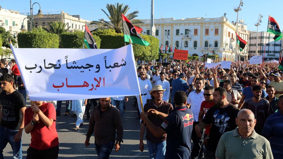 Libyans hold placards and flags during a rally in support of a rogue former general whose forces have launched a "dignity" campaign to crush jihadist militias in eastern Libya on May 30, 2014 in Tripoli. (AFP)