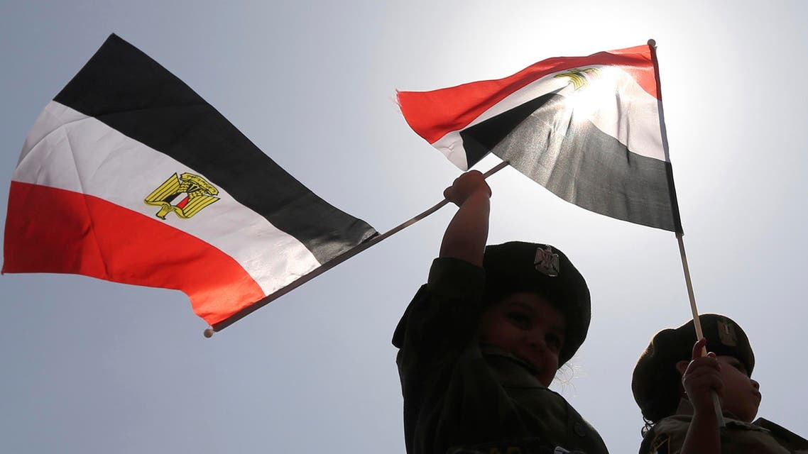 Children in army uniforms wave Egyptian flags outside a polling station on the second day of voting in the Egyptian election in Cairo, May 27, 2014. (Reuters)