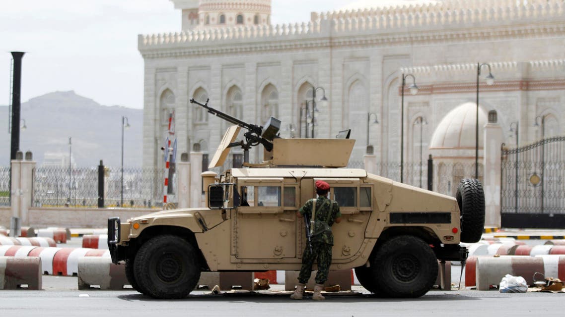 A soldier stands next to a military vehicle blocking al-Sabeen street, which leads to the presidential palace in Sanaa May 10, 2014. (Reuters)