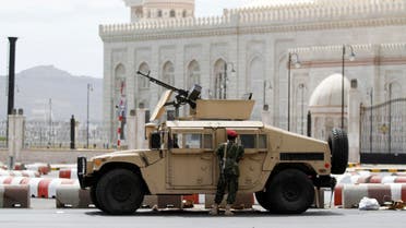A soldier stands next to a military vehicle blocking al-Sabeen street, which leads to the presidential palace in Sanaa May 10, 2014.  (Reuters)