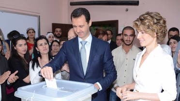 Syria's President Bashar al-Assad and his wife Asma cast their votes in the country's presidential elections at a polling station in Damascus June 3, 2014, in this handout released by Syria's national news agency SANA.(Reuters)