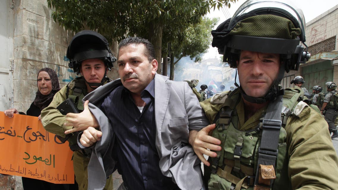 Israeli soldiers detain a Palestinian demonstrator during a protest against Israeli settlements and in support of Palestinian inmates held in Israeli jails who are in hunger strike, on June 5, 2014. (Reuters)
