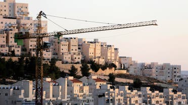 A crane is seen next to homes in a Jewish settlement near Jerusalem known to Israelis as Har Homa and to Palestinians as Jabal Abu Ghneim reuters