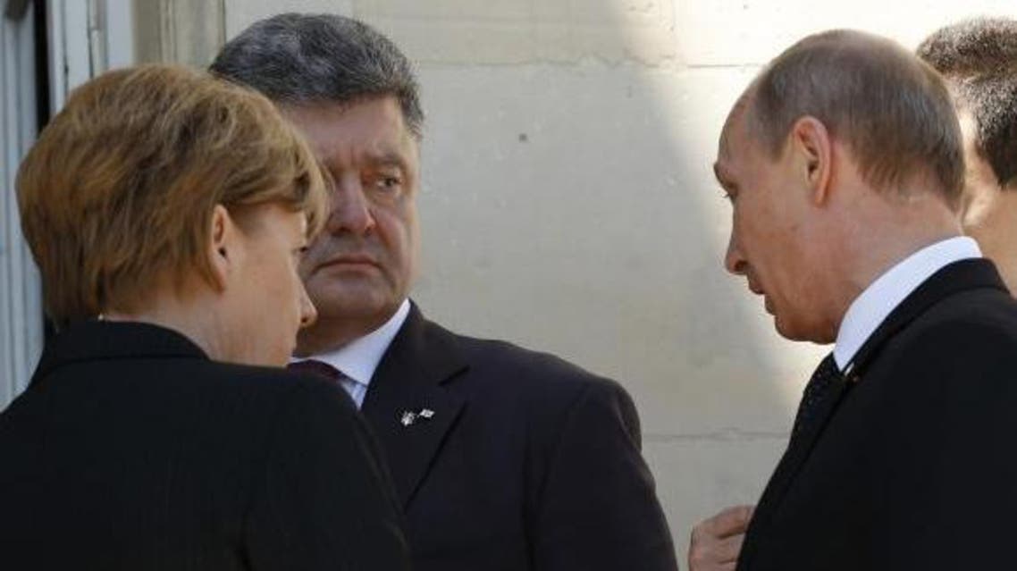Ukraine president-elect Petro Poroshenko (2nd L), German Chancellor Angela Merkel (L) and Russian President Vladimir Putin talk after a group photo in Benouville, France June 6, 2014. (Reuters)