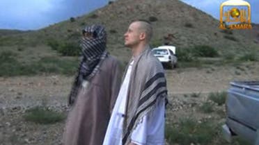 U.S. Army Sergeant Bowe Bergdahl (R) waiting at an undisclosed location in Afghanistan before his handover to US forces after five years in captivity. (AFP)
