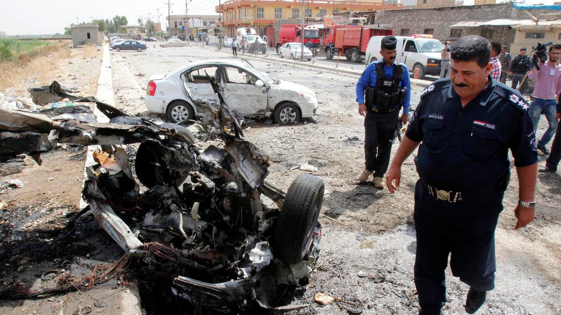 Iraqi security forces inspect the site of a car bomb attack in Kirkuk, June 4, 2014. (Reuters)
