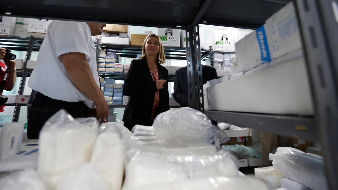 Italian Foreign Minister Federica Mogherini (C) listens to explanations by members of Red Cross and Red Crescent during her visit to a Syrian refugee camp east of Amman, June 8, 2014. (Reuters)