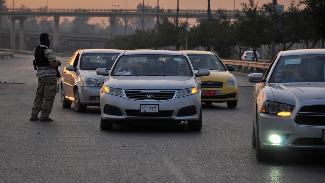 ISIS fighters stand guard at a checkpoint in the northern Iraq city of Mosul, June 11, 2014. (Reuters)