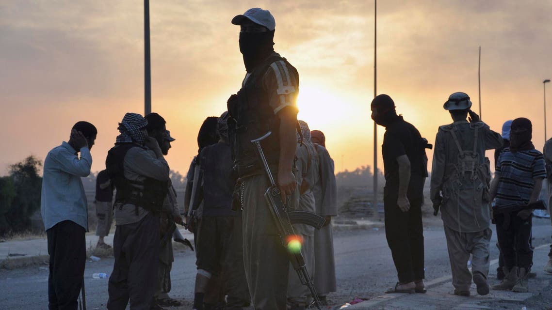 Fighters of the Islamic State of Iraq and the Levant (ISIL) stand guard at a checkpoint in the northern Iraq city of Mosul, June 11, 2014. (Reuters)