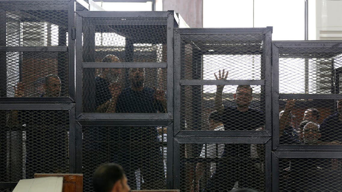 Muslim Brotherhood's General Guide Mohamed Badie (R) is pictured in a defendant's cage with other defendants in a courtroom in Cairo June 7, 2014. (Reuters)