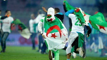 Algeria supporters wearing the Algerian national flag celebrate at a friendly. (Reuters)