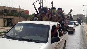 Fighters of the Islamic State of Iraq and the Levant (ISIL) celebrate on vehicles taken from Iraqi security forces, at a street in city of Mosul, June 12, 2014. (Reuters)