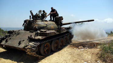 Rebel fighters are seen on a tank during what they said an offensive against forces loyal to Syria's President Bashar al-Assad who are positioned around the Armenian Christian town of Kasab May 26, 2014. (Reuters)