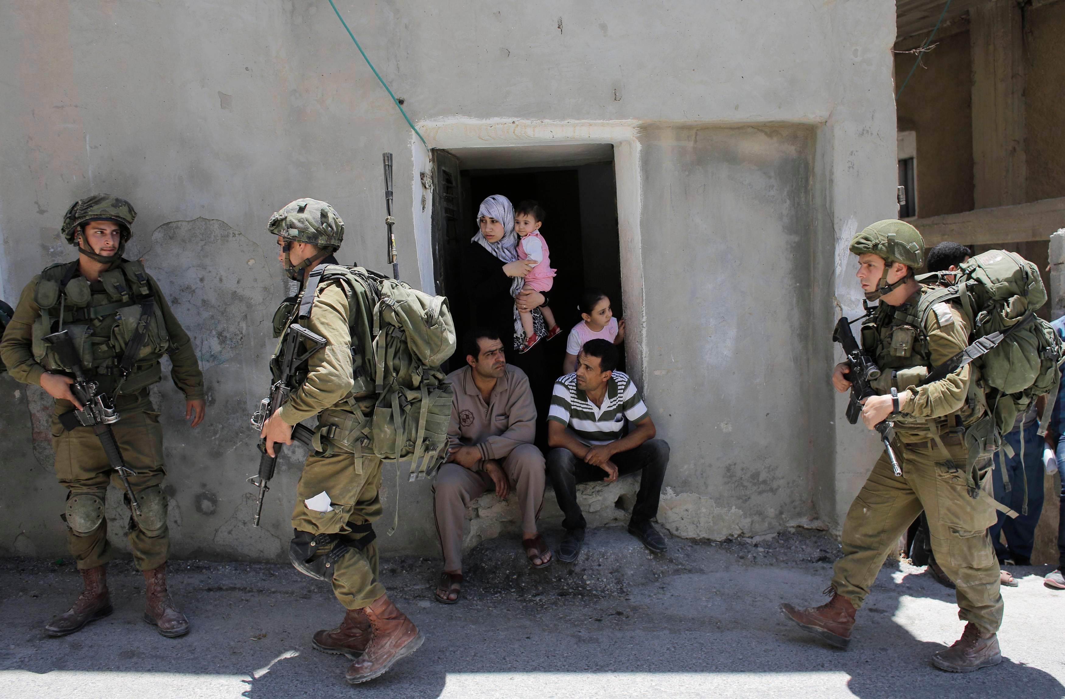 Israeli soldiers patrol near the West Bank City of Hebron