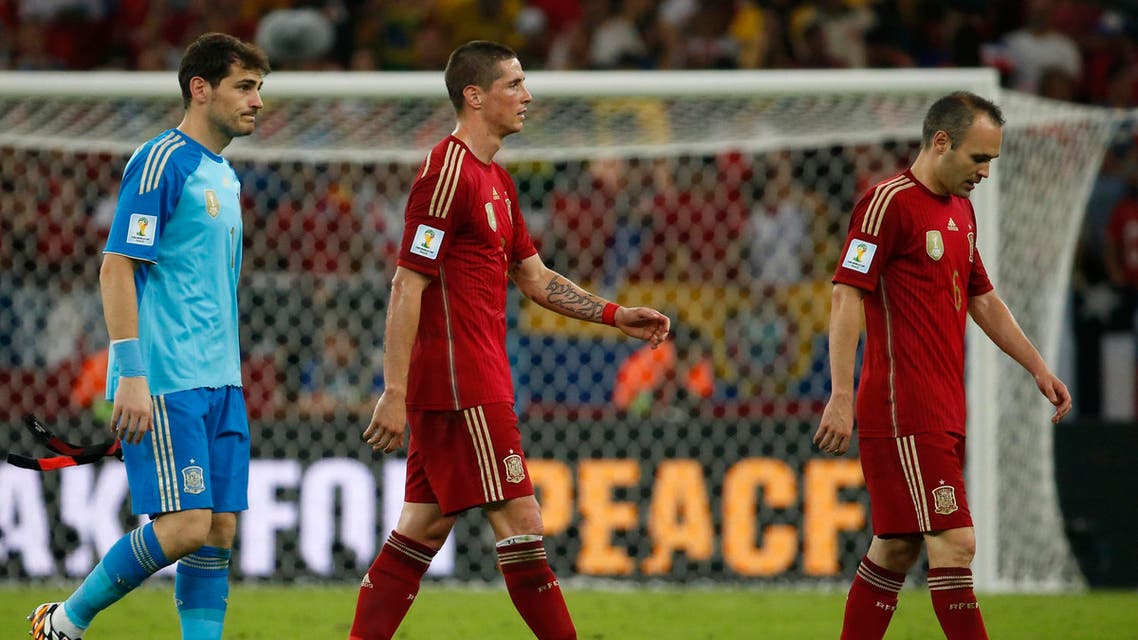 Spain's goalkeeper Iker Casillas (L), Andres Iniesta (C) and Fernando Torres walk off the field after their 2014 World Cup Group B soccer match against Chile at the Maracana stadium in Rio de Janeiro June 18, 2014. (Reuters)