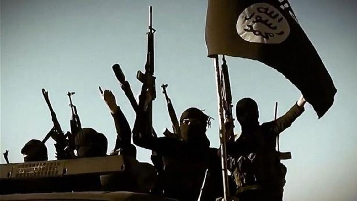 Isis fighters raise their weapons as they stand on a vehicle mounted with the trademark Jihadists flag in Anbar province. Photo: AFP/GETTY