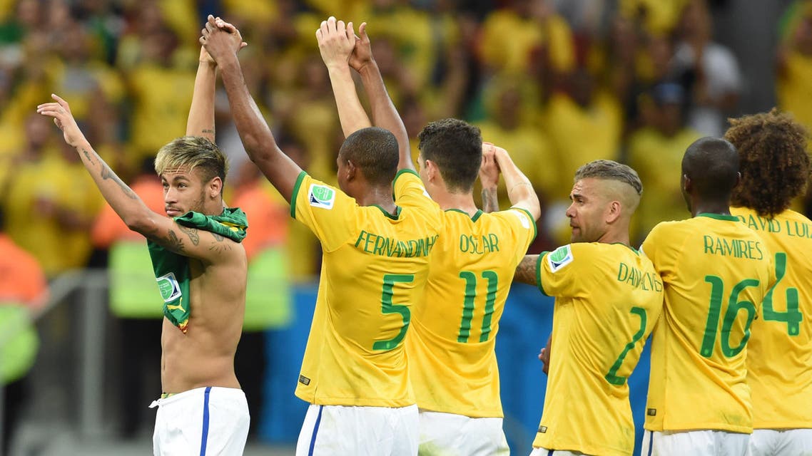 Brazil's forward Neymar (L) celebrates as he leave the pitch with teammates at the end of a Group A football match between Cameroon and Brazil at the Mane Garrincha National Stadium in Brasilia during the 2014 FIFA World Cup on June 23, 2014. (AFP)