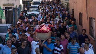 Mourners carry the coffin of Mohammed Qaraqara during his funeral in the northern town of Arabeh June 23, 2014.  