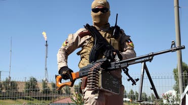 A member of the Kurdish security forces takes up position with his weapon while guarding an oil refinery, on the outskirts of Mosul, June 22, 2014. Reuters
