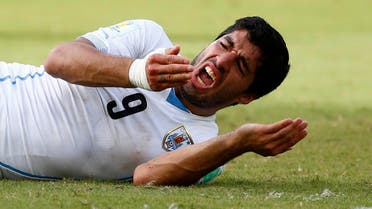 Uruguay's Luis Suarez reacts after clashing with Italy's Giorgio Chiellini during their 2014 World Cup Group D soccer match at the Dunas arena in Natal June 24, 2014. (Reuters) 