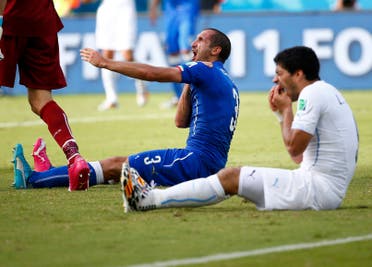 Uruguay's Luis Suarez (R) reacts after clashing with Italy's Giorgio Chiellini during their 2014 World Cup Group D soccer match at the Dunas arena in Natal June 24, 2014. reuters