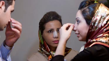 Amir Ahadi (L) and Arezoo Abassi (R) speak with Reyhaneh Ahadi about her nose surgery at the office of their surgeon Nabiollah Shariati in Tehran June 24, 2007. (Reuters)