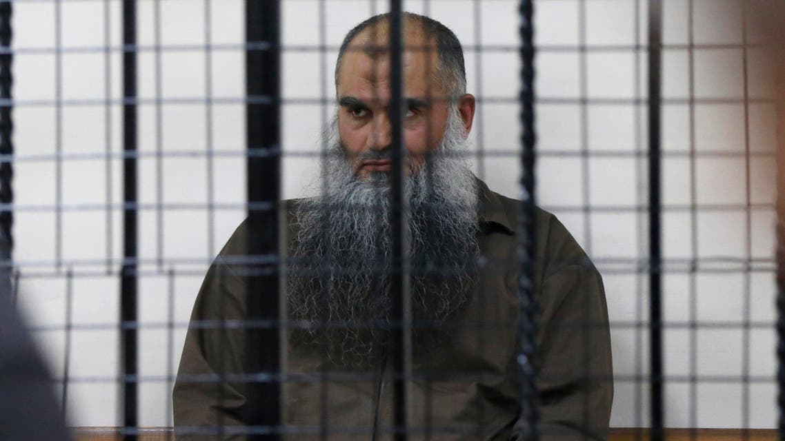 Radical Muslim cleric Abu Qatada sits behind bars at the State Security Court in Amman June 26, 2014. (Reuters)