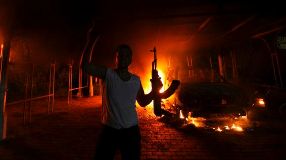 A protester reacts as the U.S. Consulate in Benghazi is seen in flames during a protest by an armed group said to have been protesting a film being produced in the United States Sept. 11, 2012. (Reuters)