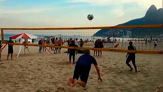 Arsenal boss Arsene Wenger performs flying header on Brazil beach