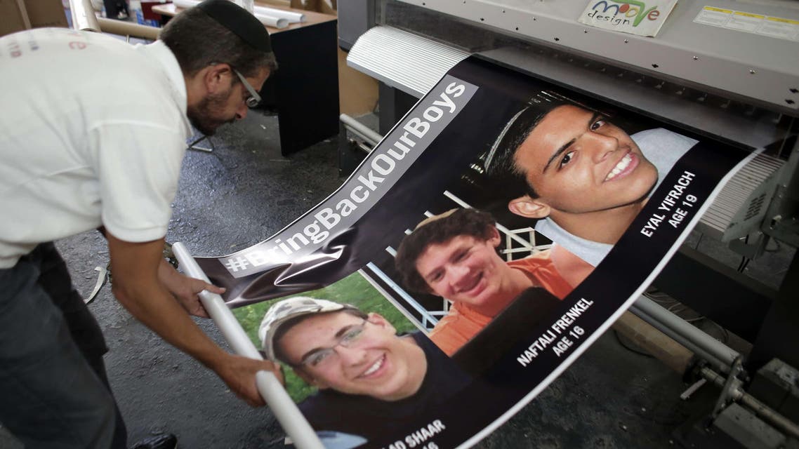  An Israeli printer finalizes posters in Jerusalem on June 23, 2014, of the three youth Israelis who disappeared from a hitchhiking stop in the southern West Bank on June 12. (AFp)