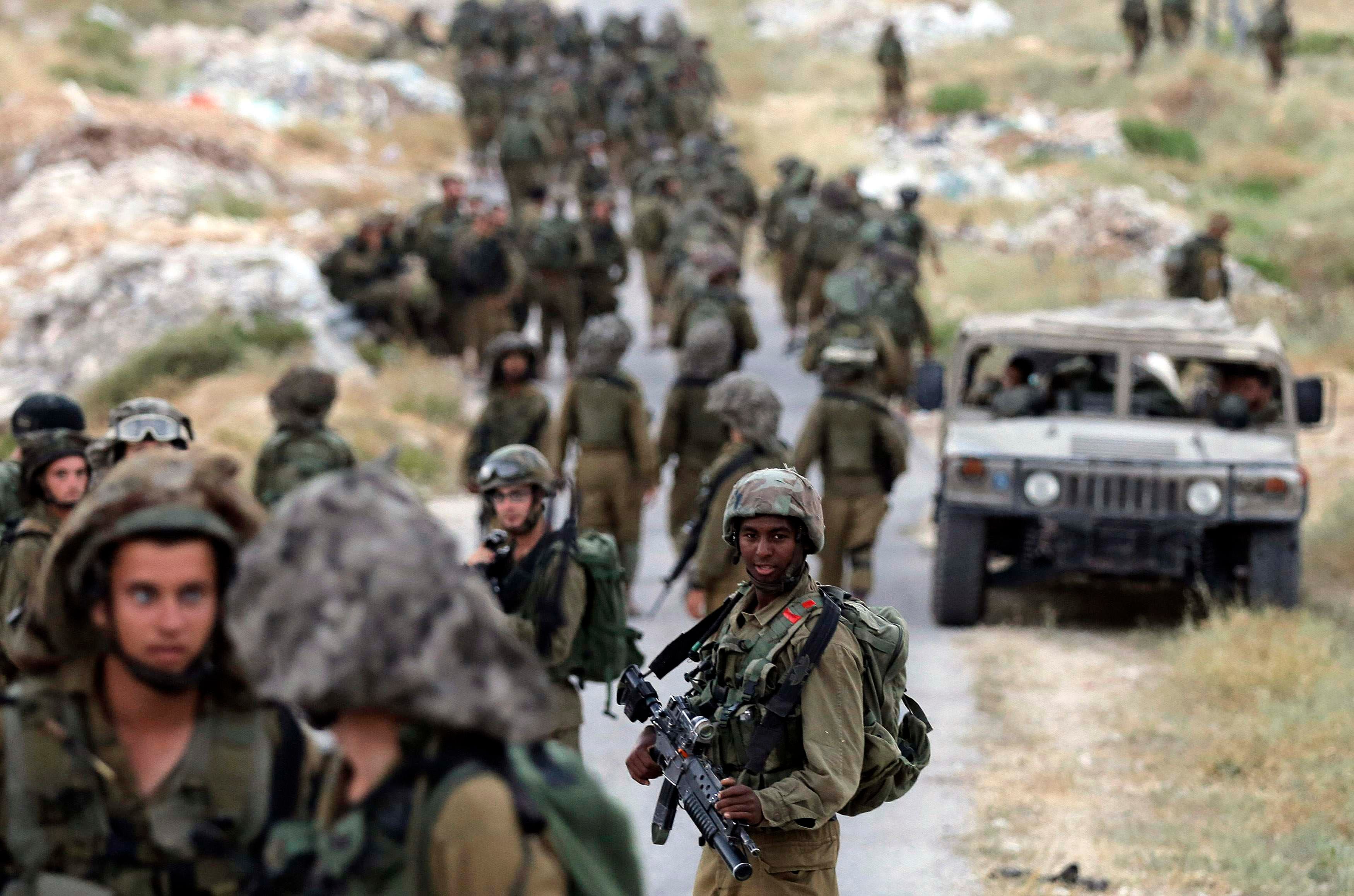 Israeli soldiers patrol near the West Bank City of Hebron
