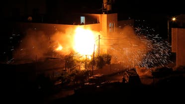Flames are seen after a blast on the top floor of the family home of an alleged abductor in the West Bank City of Hebron July 1, 2014. reuters 