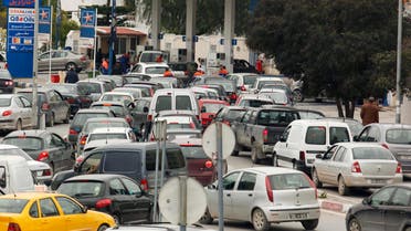 Automobiles line up for gasoline at a Staroil gas station in Tunis after the announcement of a strike by oil truck drivers in Tunisia February 8, 2011.