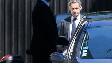 Former French President Nicolas Sarkozy (R) leaves his residence in Paris, July 2, 2014. Reuters