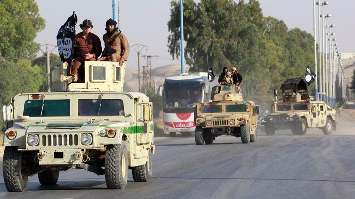 Militant Islamist fighters take part in a military parade along the streets of Syria's northern Raqqa province June 30, 2014.