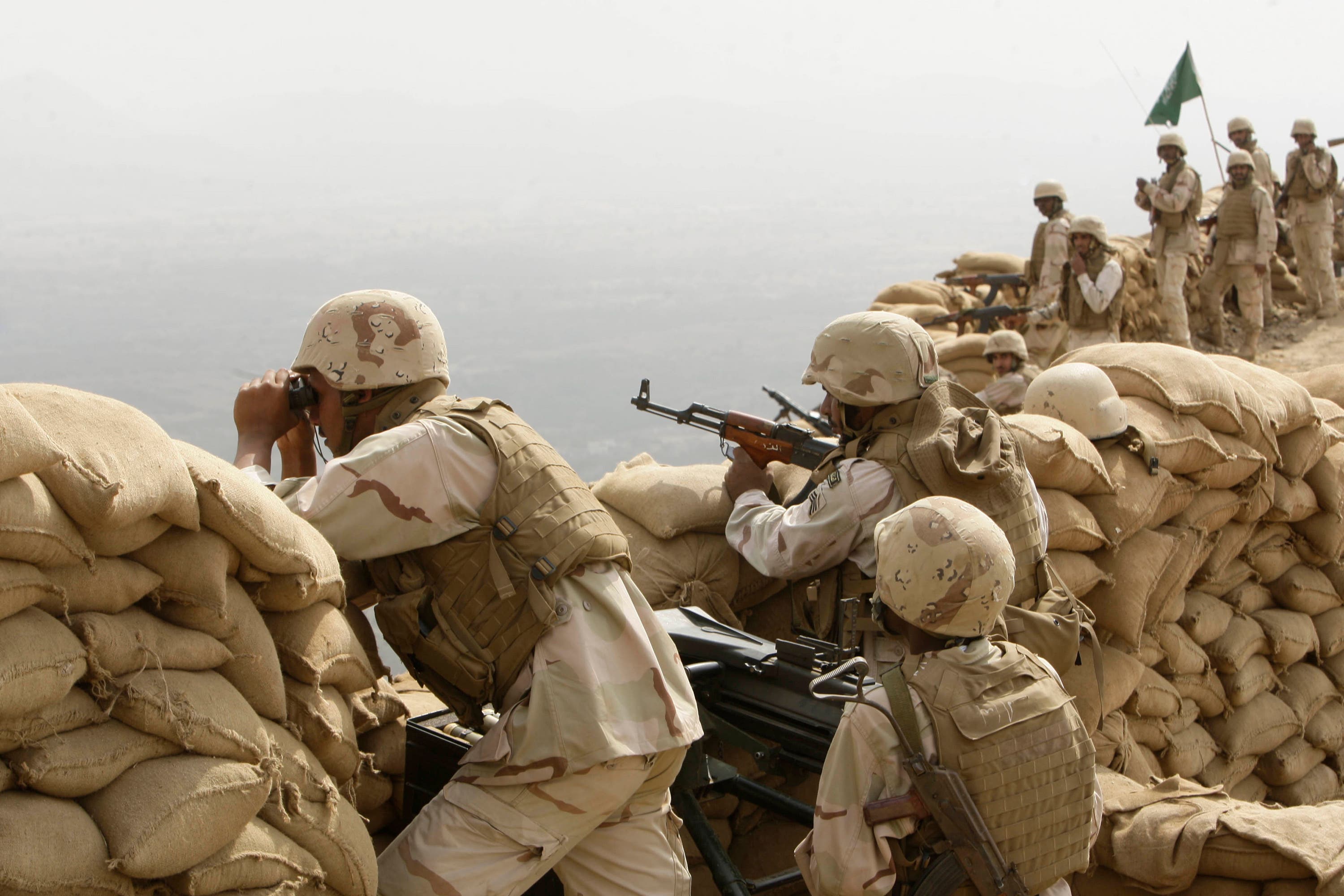 Saudi soldiers keep watch at Khoba, the frontline border with Yemen, January 27, 2010.