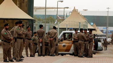 Policemen stand by on a main street in Riyadh