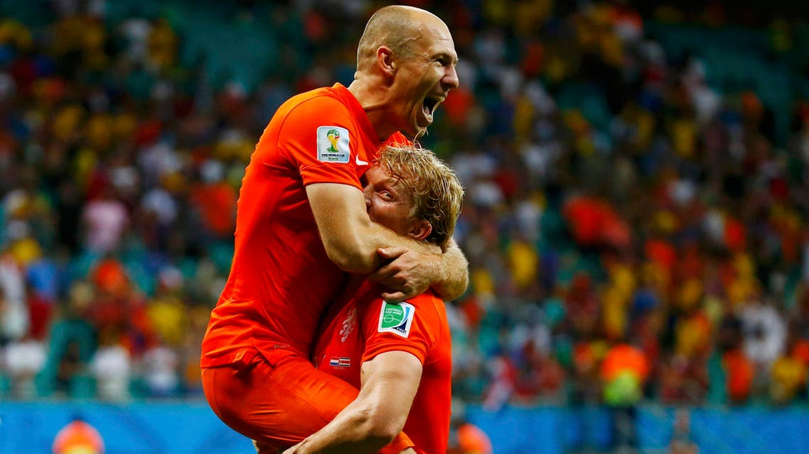 Arjen Robben of the Netherlands (top) celebrates with teammate Dirk Kuyt after they won Costa Rica in their penalty shootout