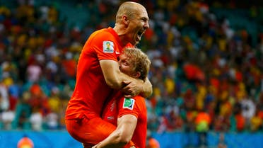 Arjen Robben of the Netherlands (top) celebrates with teammate Dirk Kuyt after they won Costa Rica in their penalty shootout 