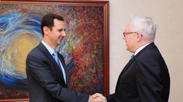 Syria's President Bashar al-Assad (L) shakes hands with Russia's Deputy Foreign Minister Sergei Ryabkov before a meeting in Damascus in this June 28, 2014