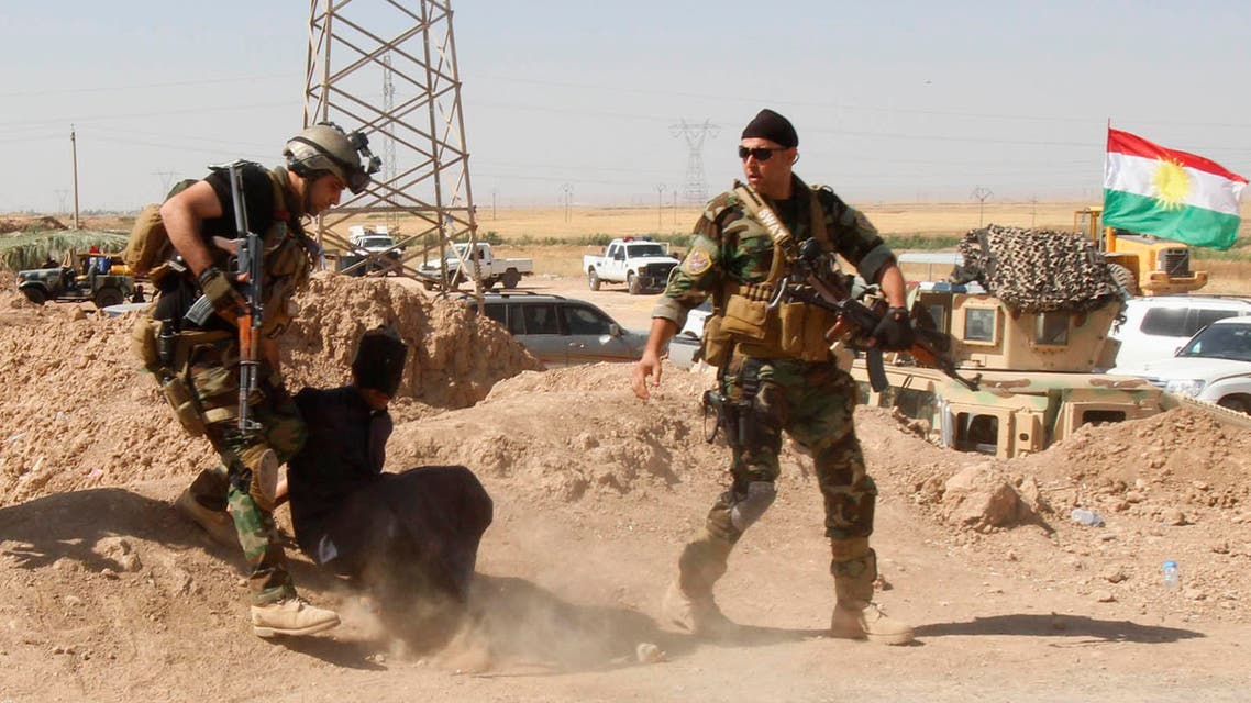 Personnel from the Kurdish security forces detain a man suspected of being a militant belonging to the al Qaeda-linked Islamic State in Iraq and the Levant (ISIL) in the outskirts of Kirkuk June 16, 2014. (Reuters)