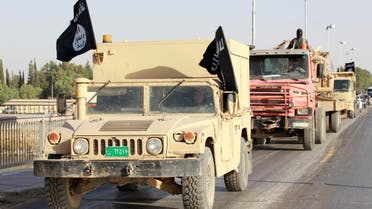 Militant Islamist fighters in military vehicles parade along the streets of Syria's northern Raqqa province June 30, 2014.  (Reuters)