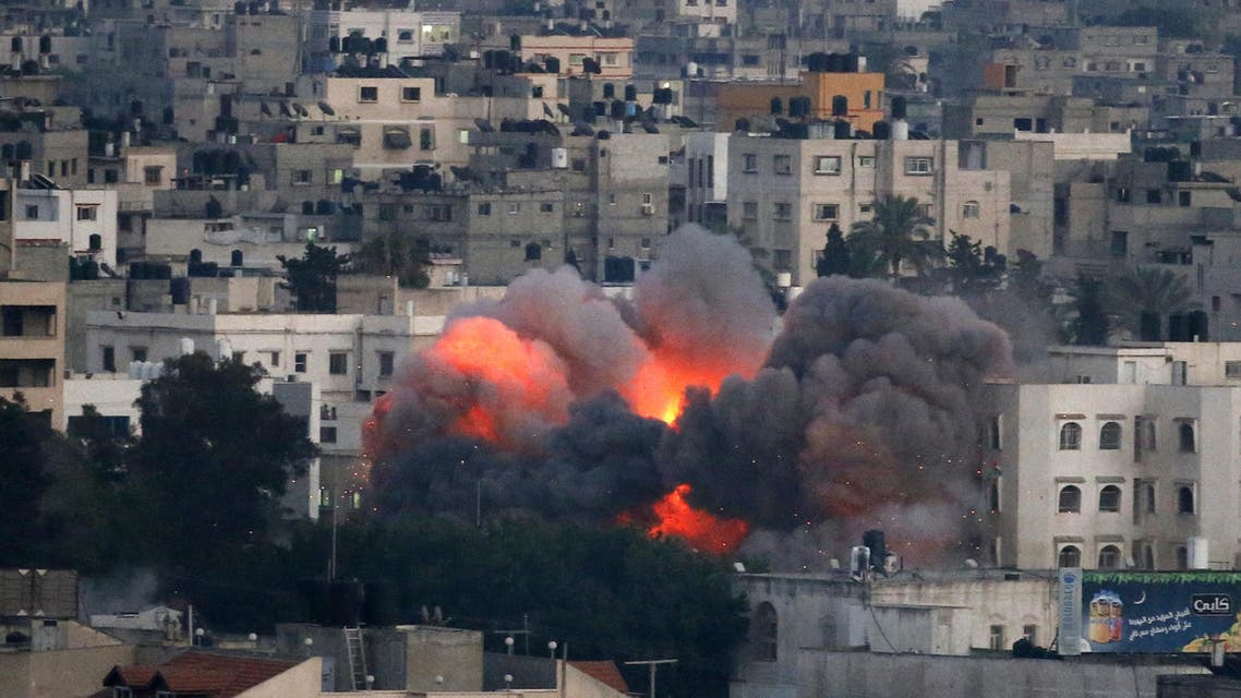 Flames erupt from a building hit by an Israeli air strike on July 9, 2014 in Gaza City. afp