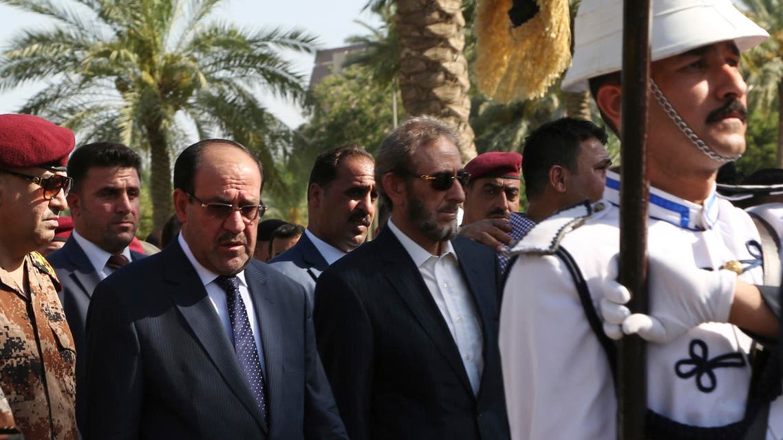 Iraq's Prime Minister Nuri al-Maliki (2nd L) and acting Defence Minister Saadoun al-Dulaimi (C) attend the funeral ceremony of Major General Negm Abdullah Ali, commander of the army's sixth division, at the defence ministry in Baghdad July 7, 2014.