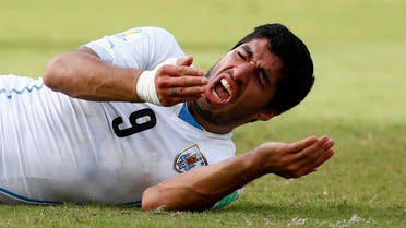 Uruguay's Luis Suarez reacts after clashing with Italy's Giorgio Chiellini during their 2014 World Cup Group D soccer match at the Dunas arena in Natal June 24, 2014. 