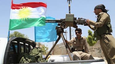 A military convoy drives towards Kirkuk, to reinforce Kurdish Peshmerga troops in Kirkuk, in this photograph taken through a window June 24, 2014.