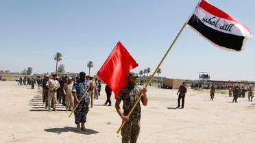 Shi'ite volunteers, who have joined the Iraqi army to fight against militants of the Islamic State, march while hilding flags during training in Baghdad July 9, 2014. (Reuters)
