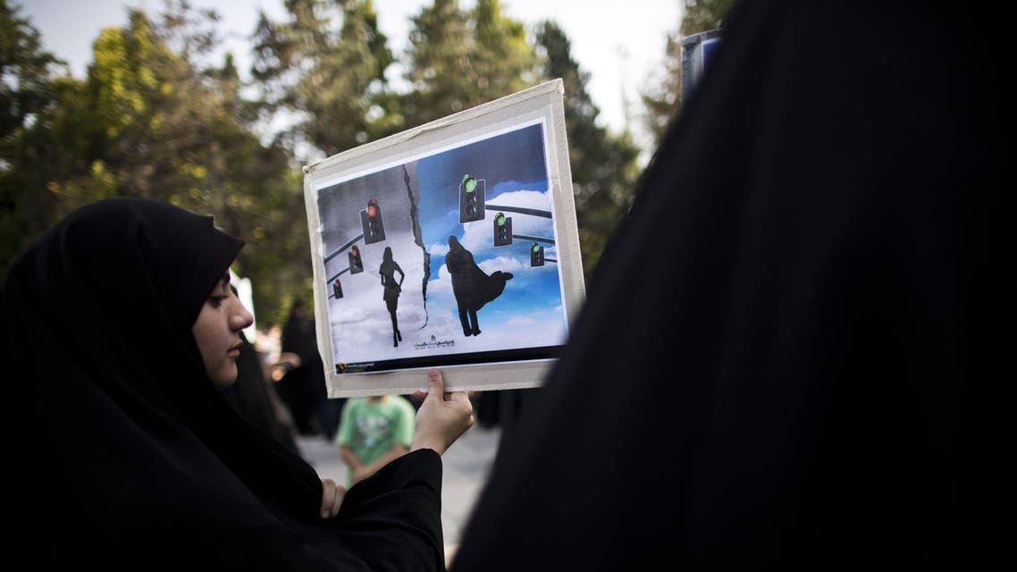 An Iranian hardliner woman holds a placard during a protest to ask for the revival of the islamic hijab and chastity in Iranian state TV programs on July 12, 2014 in Tehran. (AFP)