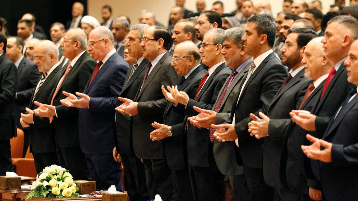 Members of the new Iraqi parliament recite verses from the Koran at the parliament headquarters in Baghdad July 1, 2014. Reuters